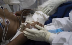 Health workers fight to save the life of a Covid-19 patient in the intensive care unit of El Salvador Hospital, on 12 August 12, 2020.