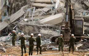 Rescuers have reported speaking to at least one trapped worker who eventually survived because he had found a pocket of air in the rubble.