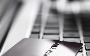 A hand enters account details on a laptop (file)