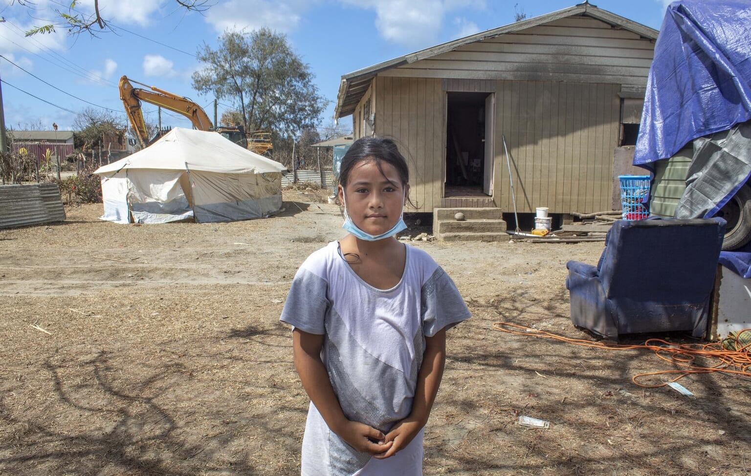 On 22 January 2022, Ma'ata Finau, 10 years old, stands in front of her home in Kanokupolu village on Tongatapu, Tongaâs main island, showing the damage caused by the Hunga Tonga-Hunga Haâapai underwater volcano eruption and tsunami.