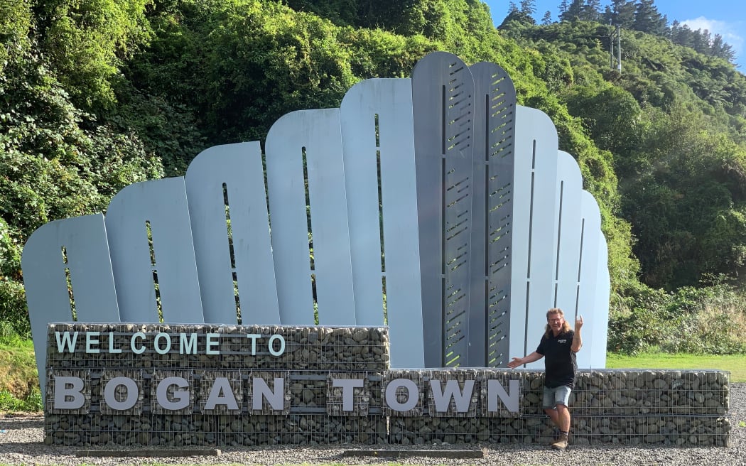 General Manager of Brewtown, Phil Gorman with the recently boganised Upper Hutt sign.