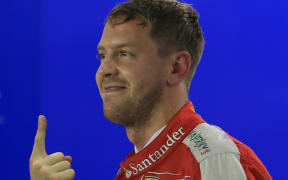Ferrari's Sebastian Vettel celebrates winning.