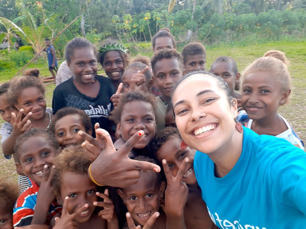 Gladys Habu shares a moment with children in Malaita during her outreach work with UNICEF on maternal and child health.