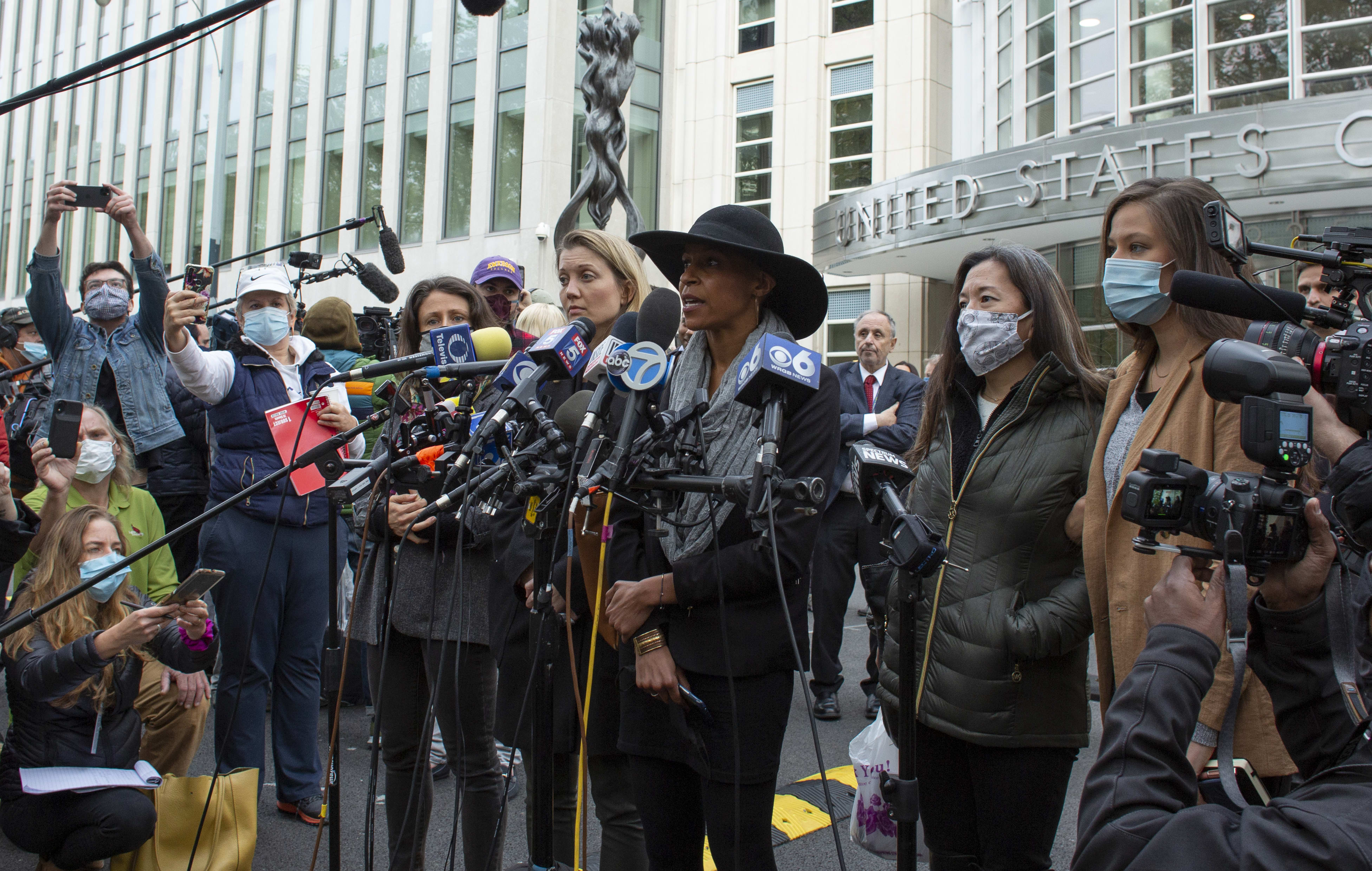 Former members of Nxivm, Linda Chung (2R), Nicki Clyne (L) and Michelle Hatchette (C) speak outside the court after Keith Raniere was sentenced to 120 years in prison.