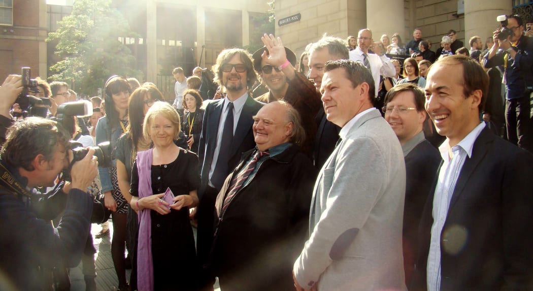 Florian Harbicht (waving) next to Pulp lead singer Jarvis Cocker, among band members and characters from the film.