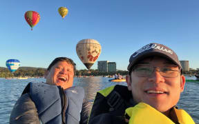 Eric Vu and William Lam were kayaking on Lake Burley Griffin when they had a close encounter with a hot air balloon.