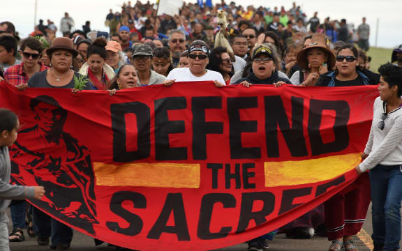 Native Americans march to a burial ground sacred site that was disturbed by bulldozers building the Dakota Access Pipeline (DAPL).
