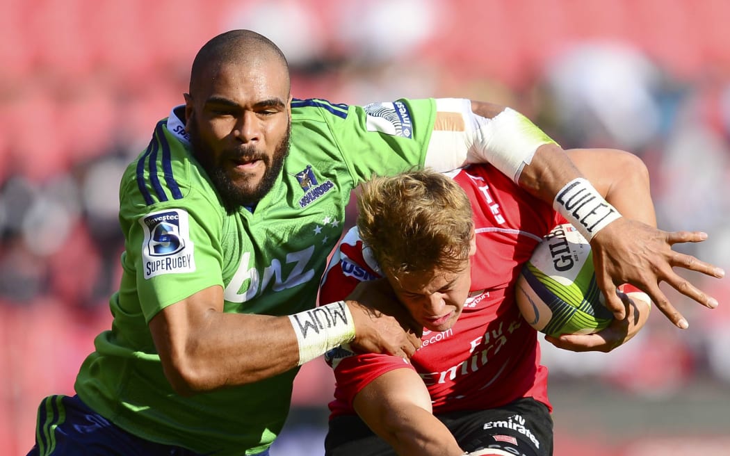 Andries Coetzee of the Lions tackled by Patrick Osborne of the Highlanders.