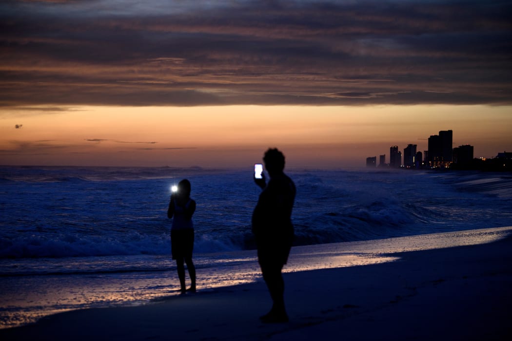 People visit the beach while waiting for Hurricane Michael in Panama City Beach, Florida.