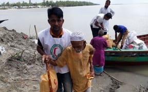 The Bangladesh Red Crescent Society distributes rice, dal, oil and semolina to about 650 people in a flood-affected area near Sirajganj on 27 August, 2017.