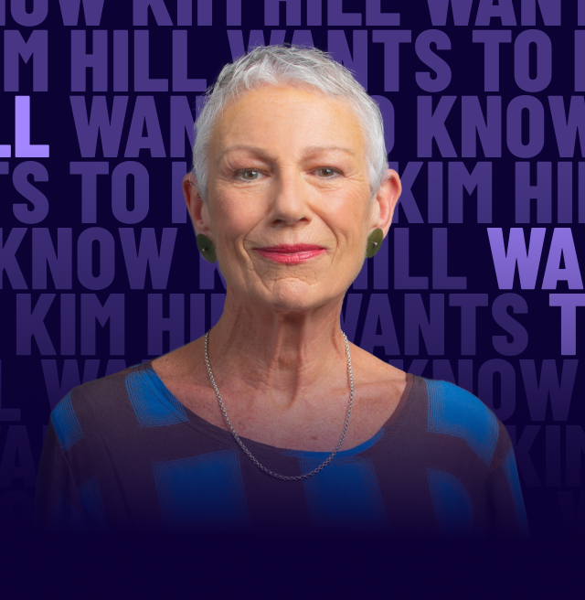 A woman with short grey hair half-smiles in front of a background of repeating text with "Kim Hill Wants to Know" highlighted