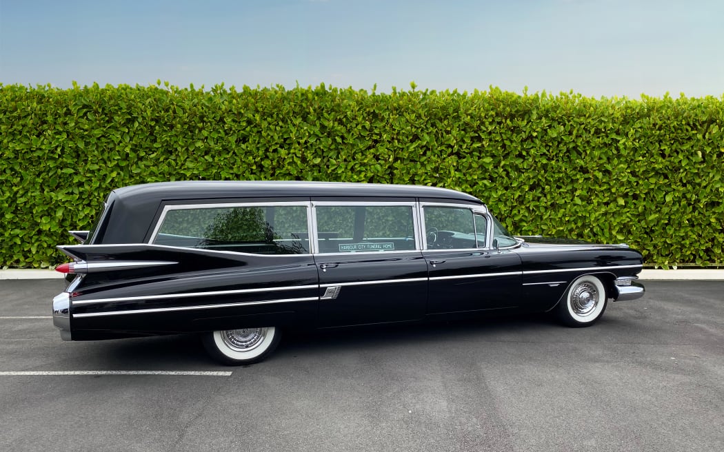 The hearse which is a 1959 black Cadillac is named Colin in honour of Wellington designer and graphic artist Colin Simon.