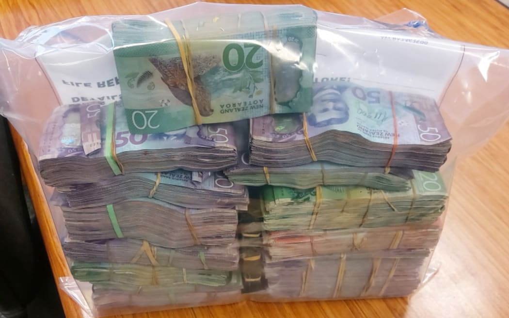 Ashburton police have arrested two men, seized $200,000 in cash and uncovered a significant stash of firearms and cannabis after an operation targeting illegal drugs in the town.