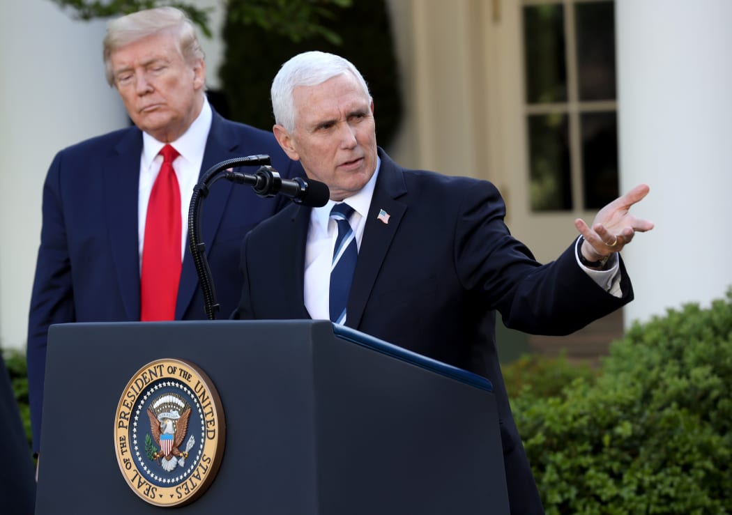 President Donald Trump listens as Vice president Mike Pence answers questions during the daily briefing of the coronavirus task force in the Rose Garden of the White House on April 27, 2020 in Washington, DC.