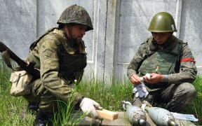 Russian-allied Luhansk People's Republic soldiers prepare weapons, in Severodonetsk, Ukraine, on 29 May.