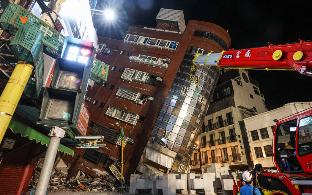 This photo taken by Taiwan's Central News Agency (CNA) on April 3, 2024 shows the damaged Uranus Building in Hualien, after a major earthquake hit Taiwan's east. A major 7.4-magnitude earthquake hit Taiwan's east on the morning of April 3, prompting tsunami warnings for the self-ruled island as well as parts of southern Japan and the Philippines. (Photo by CNA / AFP) / Taiwan OUT - China OUT - Macau OUT / Hong Kong OUT RESTRICTED TO EDITORIAL USE