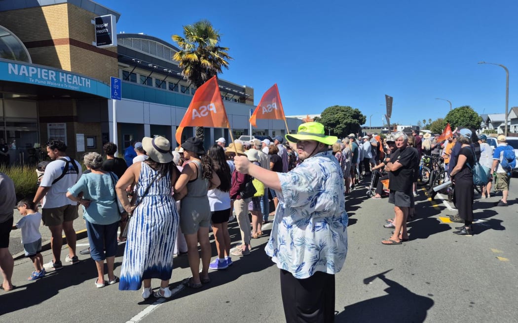 About 250 people formed a human chain outside Napier Health to protest cuts to urgent after-hours services.