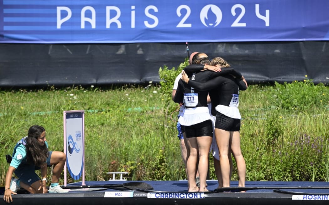 New Zealand's gold medallists Lisa Carrington, Alicia Hoskin, Olivia Brett and Tara Vaughan celebrate winning in the women's kayak four 500m final of the canoe sprint competition at Vaires-sur-Marne Nautical Stadium in Vaires-sur-Marne during the Paris 2024 Olympic Games on August 8, 2024. (Photo by Olivier MORIN / AFP)