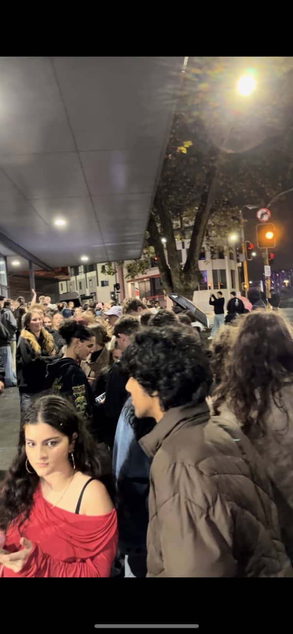 People queueing in the rain.