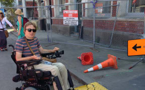 Johnny Bourke in the city centre next to a broken access ramp, which is an access barrier (picture taken this year).