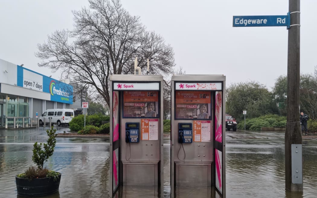 Phone booths under water on Edgeware Road, Christchurch, 26 July 2022.