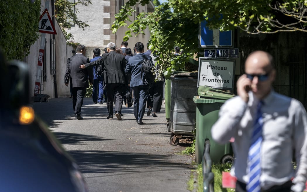 Members of the Chinese delegation walk to the residency of the permanent Swiss ambassador to the United Nations offices in Geneva during talks between Seniors US and Chinese officials on tariffs in Geneva, on May 10, 2025. Senior US and Chinese officials were meeting in Geneva in a bid to de-escalate a trade war sparked by President Donald Trump's sweeping tariff roll-out and further fuelled by Beijing's robust retaliation. (Photo by Fabrice COFFRINI / AFP)