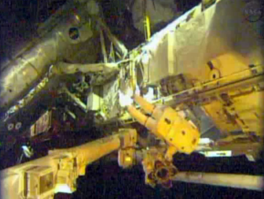 The astronauts are repairing a faulty cooling system.