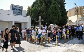 People queue outside the funeral chapel for the public wake of Liverpool's Portuguese forward Diogo Jota and his brother Andre Silva in Gondomar, on the outskirts of Porto, on July 4, 2025. Liverpool forward Diogo Jota and his brother Andre Silva died in a car crash in northwestern Spain early July 3, sparking widespread grief just after the Portugal star had got married. (Photo by MIGUEL RIOPA / AFP)