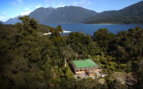 Aerial shot of Charlie Paterson's wilderness lodge at Jamestown on the shore of Lake McKerrow in the Hollyford Valley.