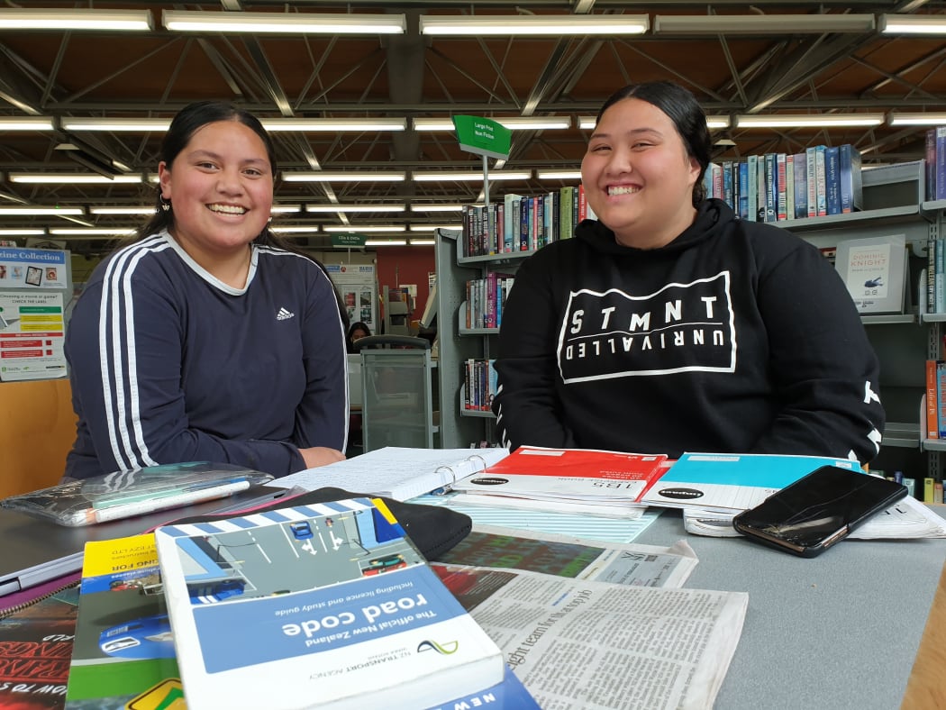 Elizabeth Lafaele (left) and Naria Aukisitino studying at the Ruth Gotlieb Library in Kilbirnie Wellington.