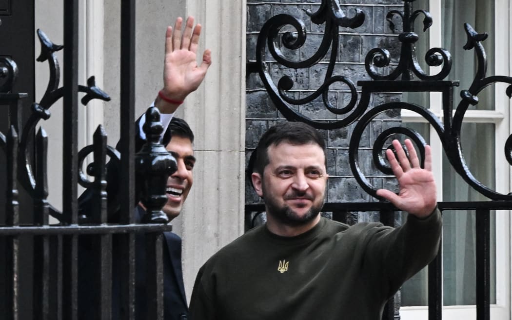 Ukraine's President Volodymyr Zelensky, right, waves as he arrives with Britain's Prime Minister Rishi Sunak at 10 Downing Street in central London on February 8, 2023, ahead of their meeting.
