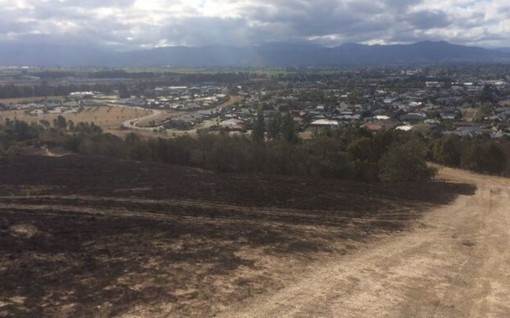 The damage from the recent blazes can be seen clearly on the hills above Blenheim.