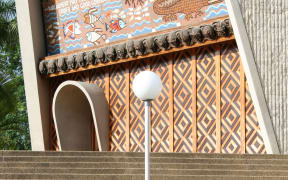 The front facade of Papua New Guinea's parliament featuring recently removed anthropomorphic carved heads on the front lintel.
