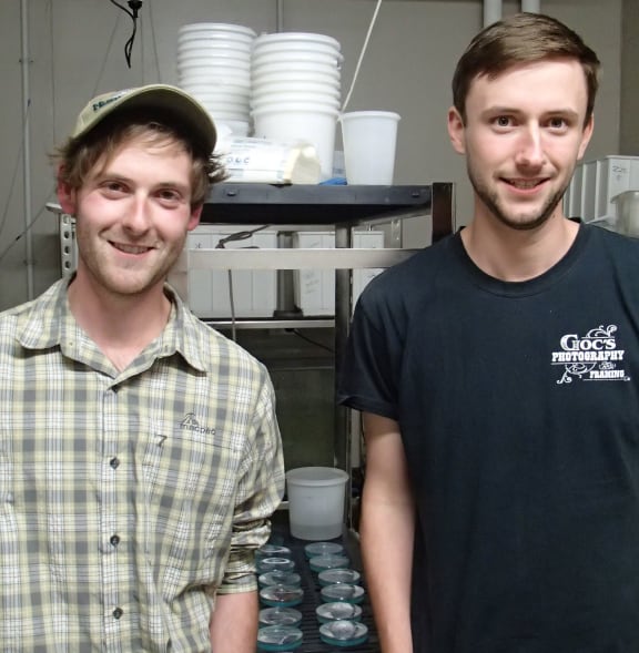 Two young men standing in a wet lab at the university