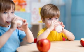 children eating healthy food at home or kindergarten