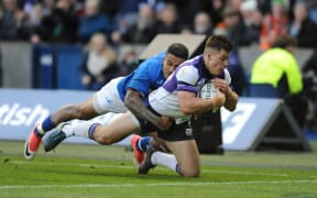Scotland centre Huw Jones beats the tackle of Samoa centre Reynold Lee-lo.