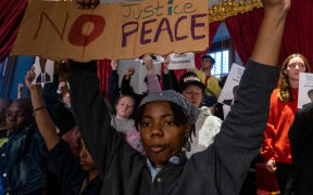 NASHVILLE, TN - APRIL 06: Protesters calling for gun reform laws and showing support for the three Democratic representatives who are facing expulsion, stand in the House gallery as legislators start the morning session at the Tennessee State Capitol building on April 6, 2023 in Nashville, Tennessee. Democratic Reps. Justin Pearson of Memphis, Justin Jones of Nashville, and Gloria Johnson of Knoxville face expulsion from the state legislature after they led a protest at the Capitol in the wake of a mass shooting where three students and three adults were killed on March 27 at the Covenant School in Nashville.   Seth Herald/Getty Images/AFP (Photo by Seth Herald / GETTY IMAGES NORTH AMERICA / Getty Images via AFP)