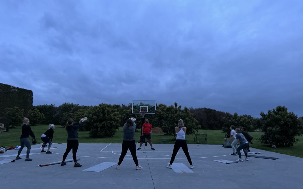 Photo of people doing workouts together.