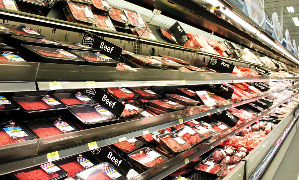 Meat and poultry products on shelves in a supermarket