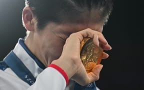 Gold medallist Taiwan's Lin Yu-ting celebrates on the podium during the medal ceremony for the women's 57kg final boxing category. Paris 2024 Olympic Games.