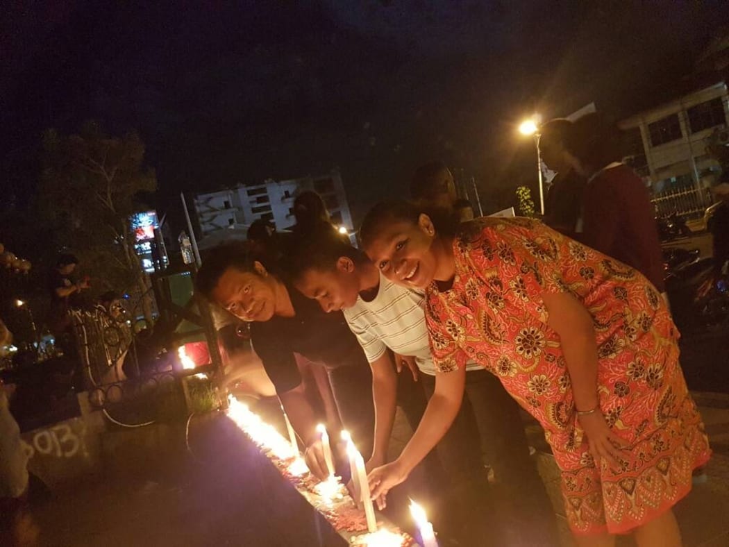 People in Jayapura light candles to show support for the jailed former governor of Jakarta, Ahok.