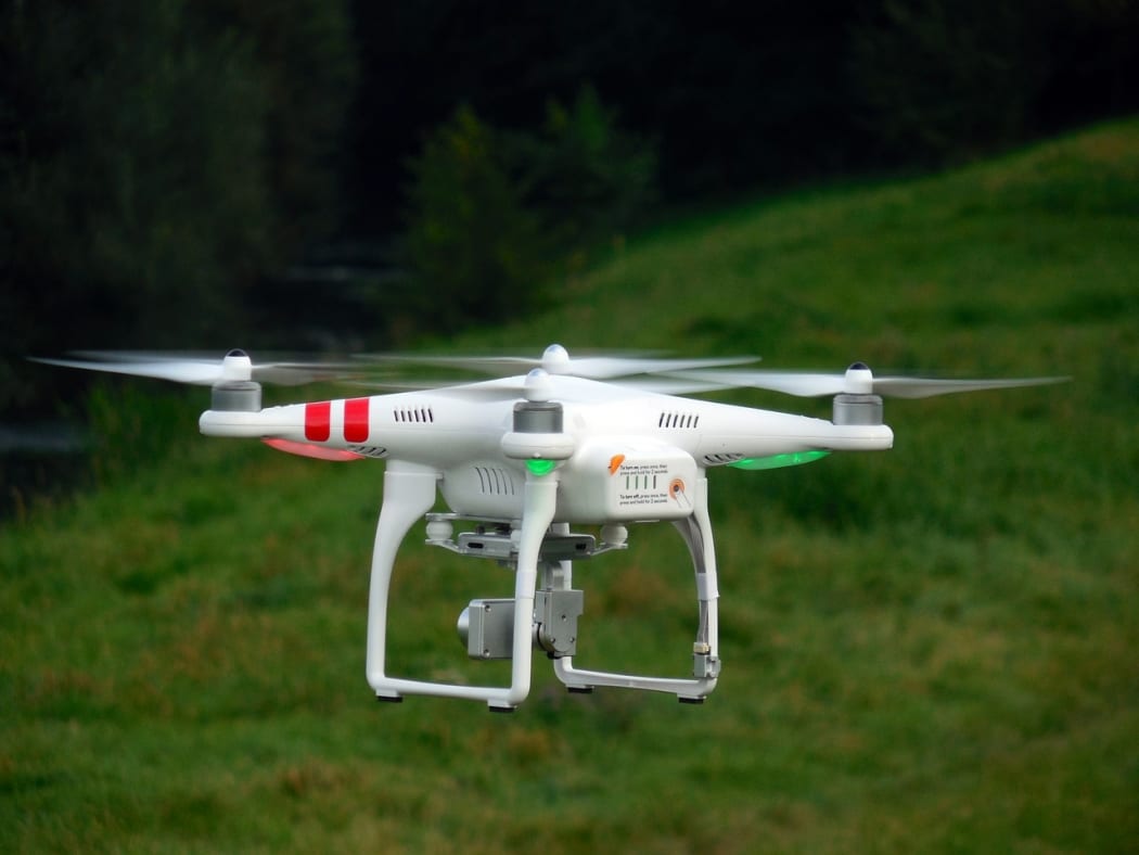 A drone near the woods.