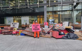 Greenpeace activists blocked an entrance to Fonterra's Auckland office with what they said was flood-damaged furniture in a protest over greenhouse gas emissions.