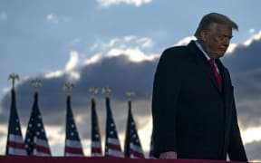 Former US president Donald Trump addresses guests at Joint Base Andrews in Maryland on January 20, 2021.