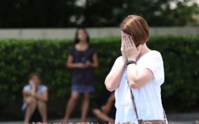 A woman prays at a site about a block from the Pulse nightclub in the aftermath of a mass shooting in Orlando, Florida, on June 12, 2016.