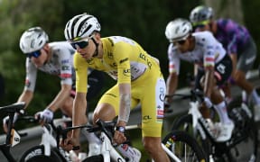 UAE Team Emirates - XRG team's Slovenian rider Tadej Pogacar wearing the overall leader's yellow jersey cycles with the pack of riders (peloton) during the 15th stage of the 112th edition of the Tour de France cycling race, 169.3 km between Muret and Carcassonne, southwestern France, on July 20, 2025. (Photo by Loic VENANCE / AFP)