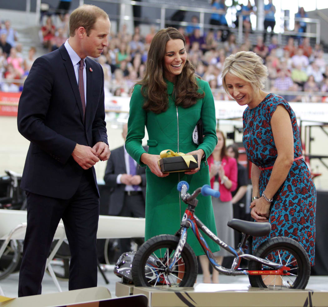 Prince William and Catherine are gifted a bike for baby George, with Olympic gold medallist Sarah Ulmer looking on.