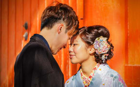 A Japanese bride and groom in traditional costume for their wedding ceremony.