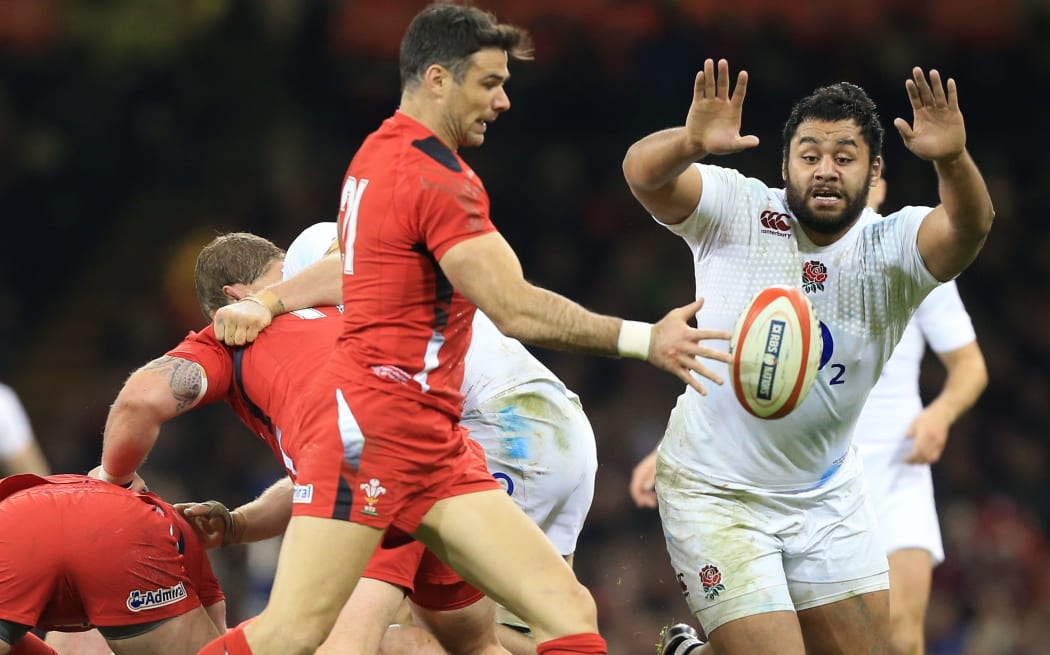 England's Billy Vunipola tries to charge down a kick from Wales scrum-half Mike Phillips, February, 2015.