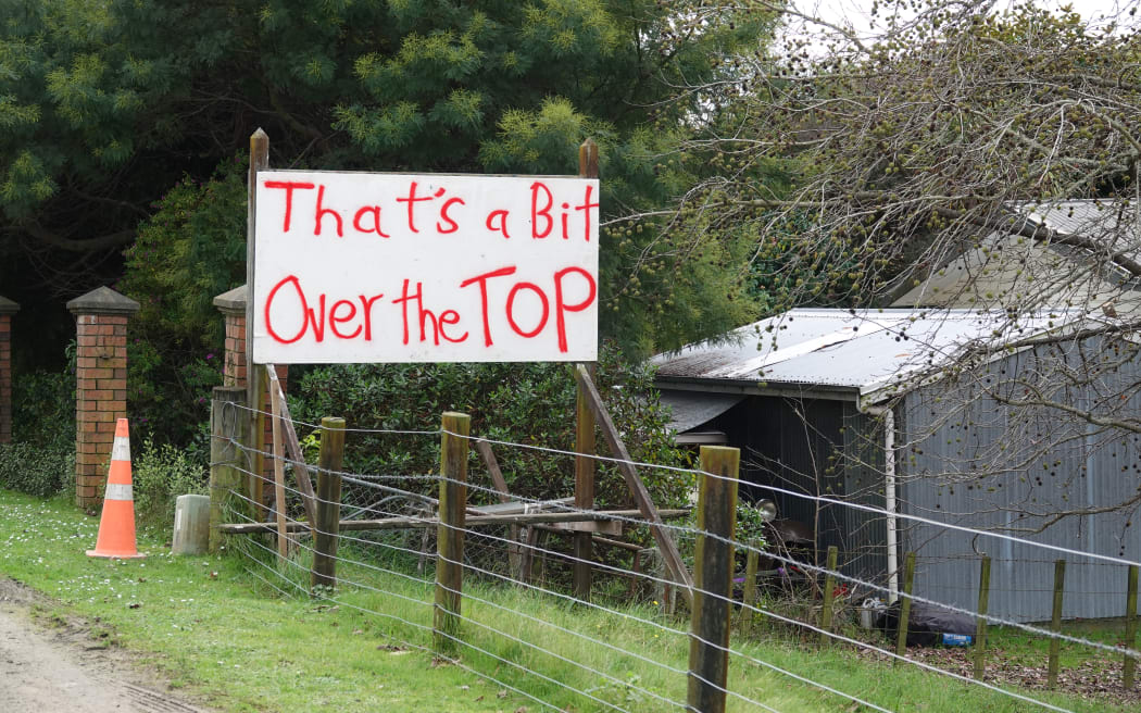 Signs alongside the main street through Puketapu mix humour with a serious message.
